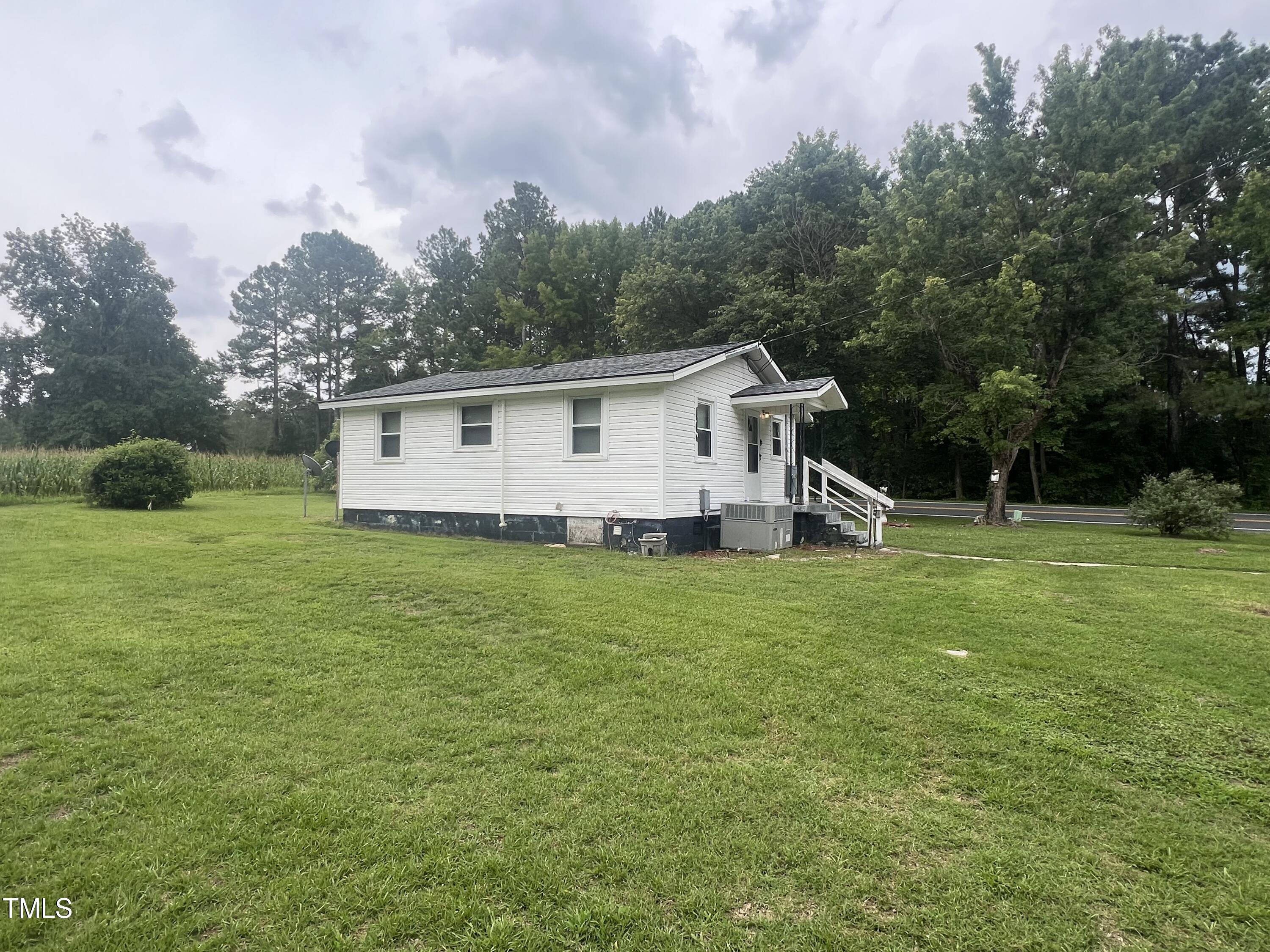 2001 Pearidge Road Angier, NC 27501 - Photo 11 of 13 a view of a house with backyard and garden
