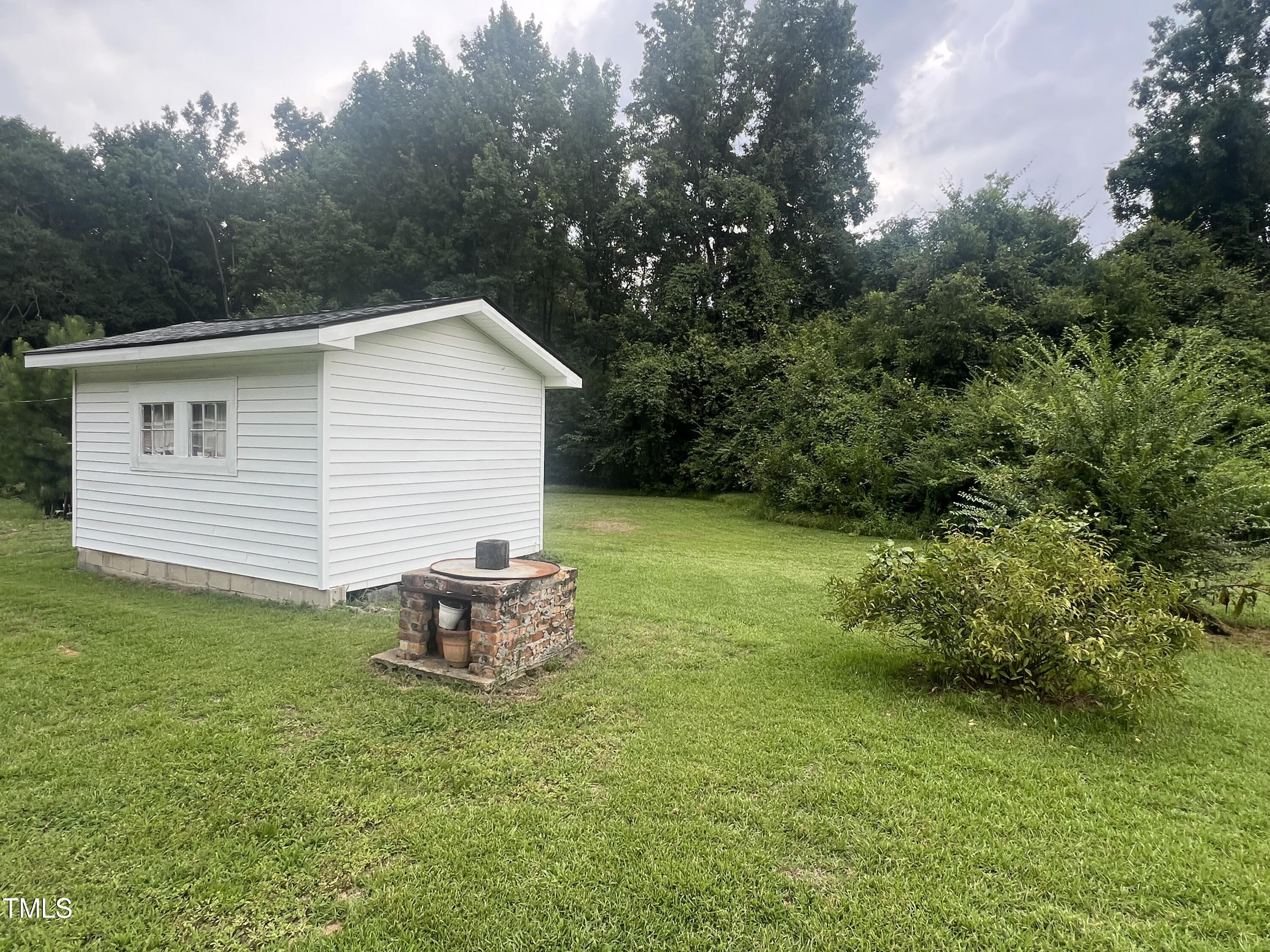 2001 Pearidge Road Angier, NC 27501 - Photo 13 of 13 a backyard of a house with table and chairs