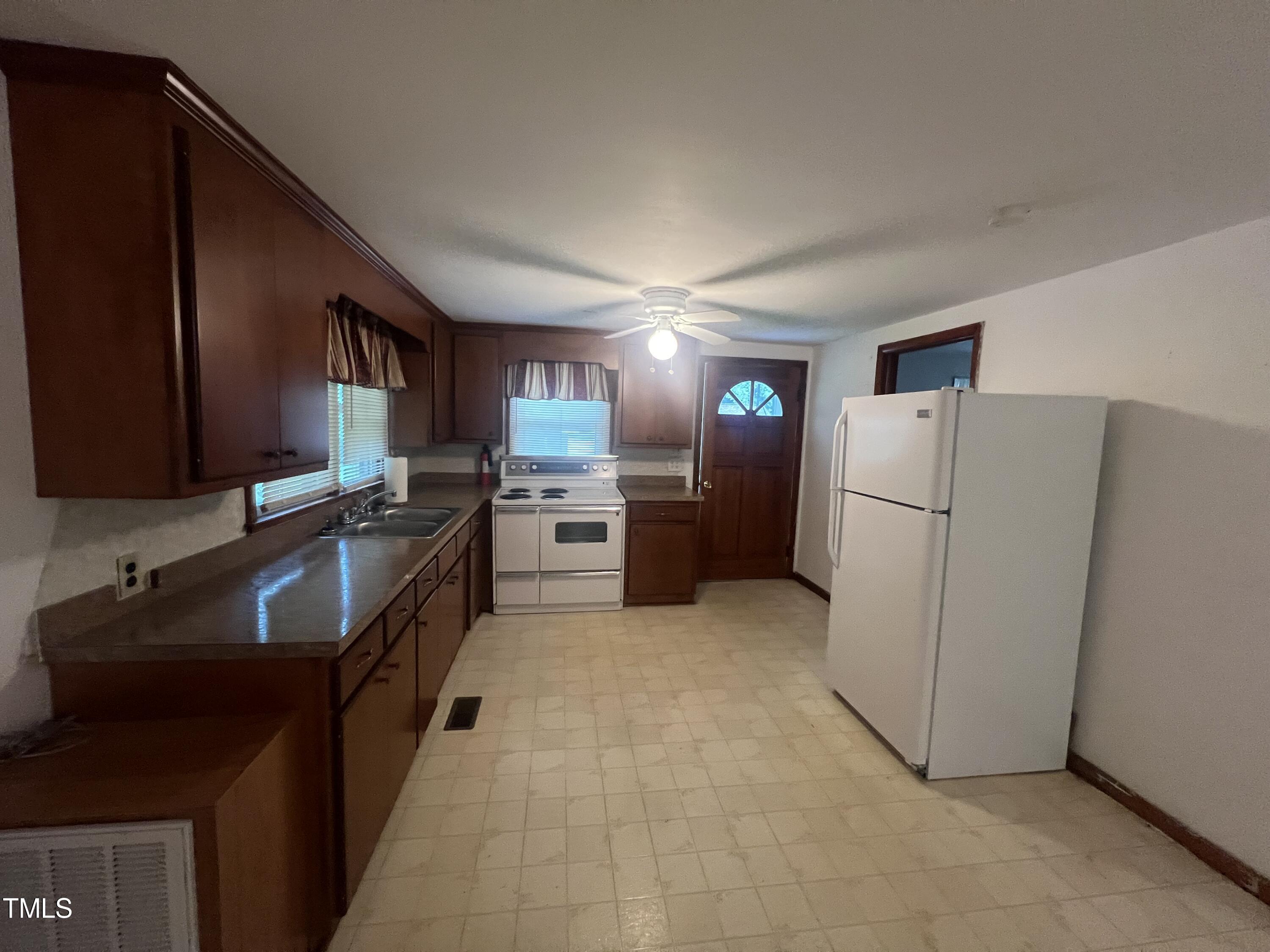 2001 Pearidge Road Angier, NC 27501 - Photo 3 of 13 a kitchen with refrigerator and cabinets
