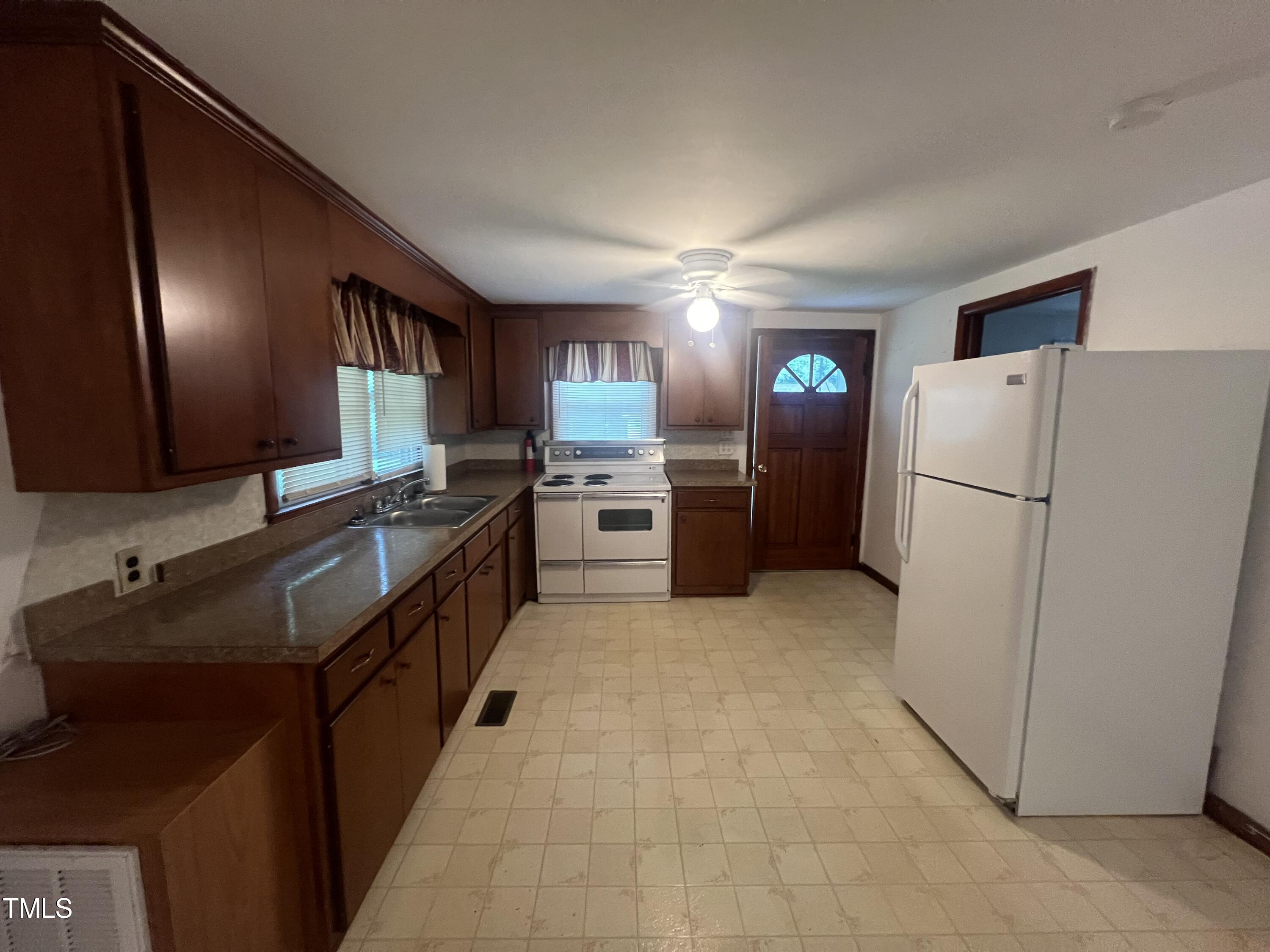 2001 Pearidge Road Angier, NC 27501 - Photo 4 of 13 a kitchen with a refrigerator and a sink