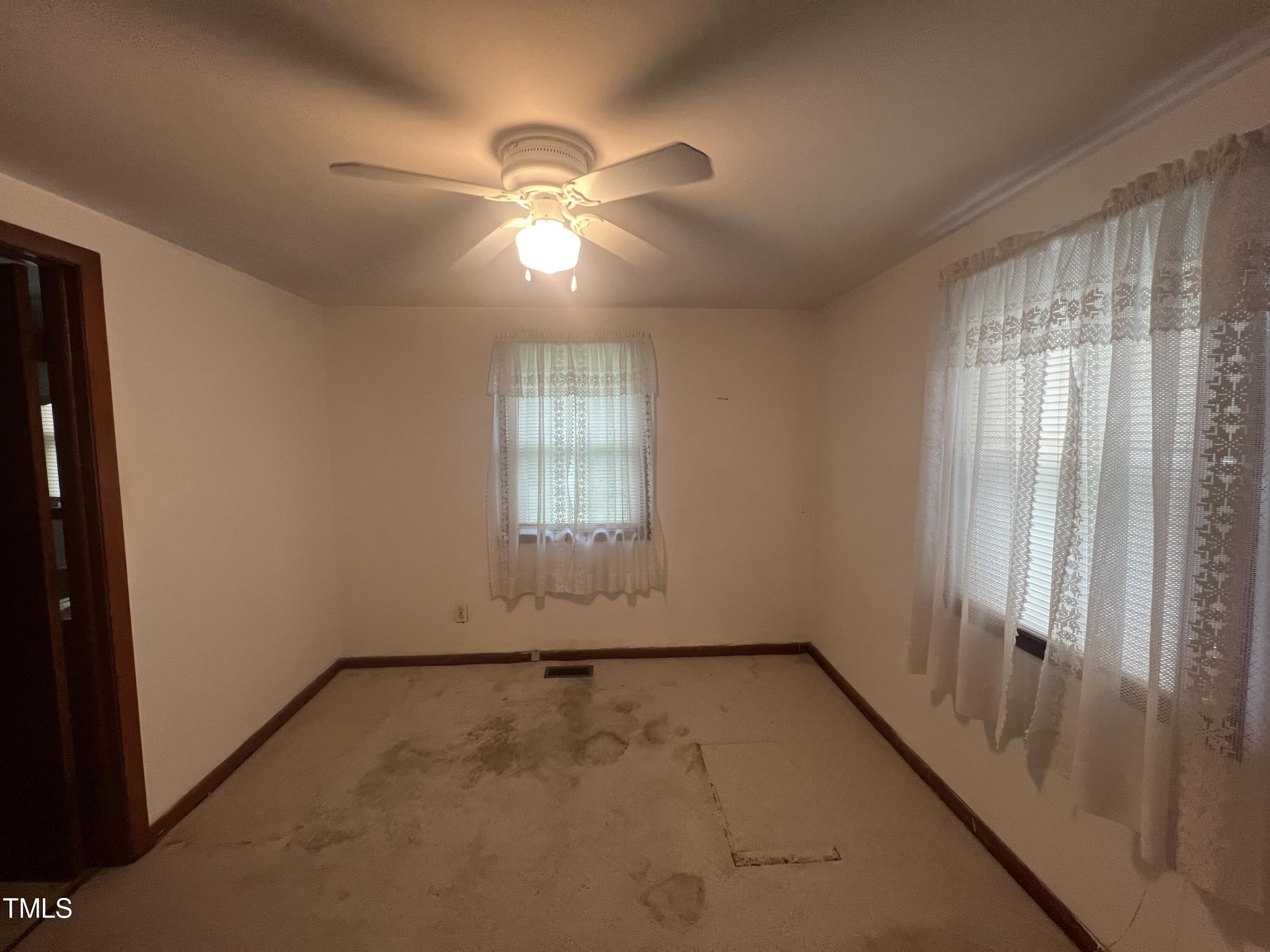 2001 Pearidge Road Angier, NC 27501 - Photo 8 of 13 an empty room with windows and chandelier fan
