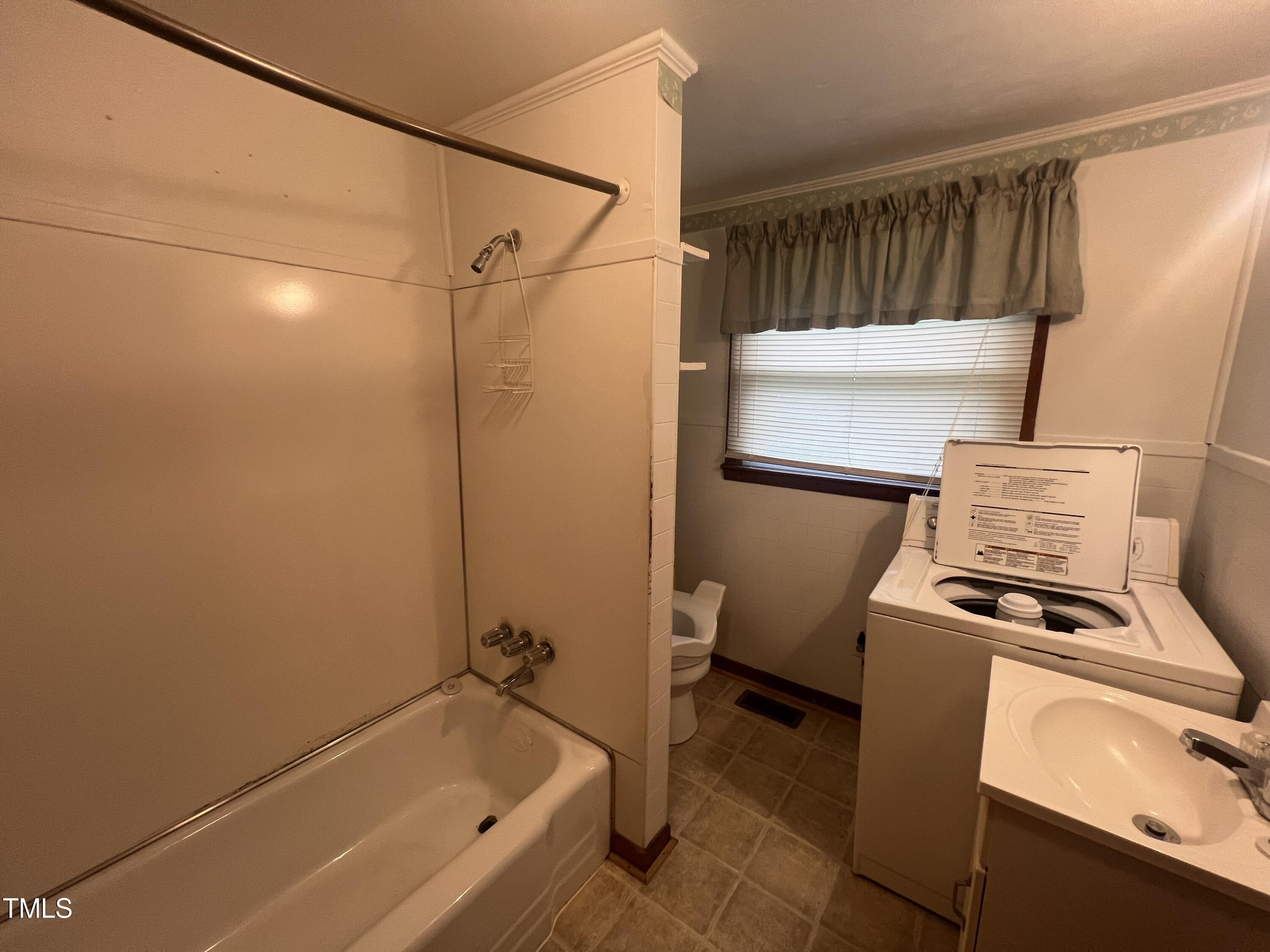 2001 Pearidge Road Angier, NC 27501 - Photo 9 of 13 a bathroom with a tub toilet and sink