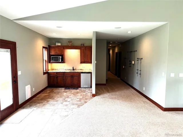 a view of a kitchen with a sink and a refrigerator