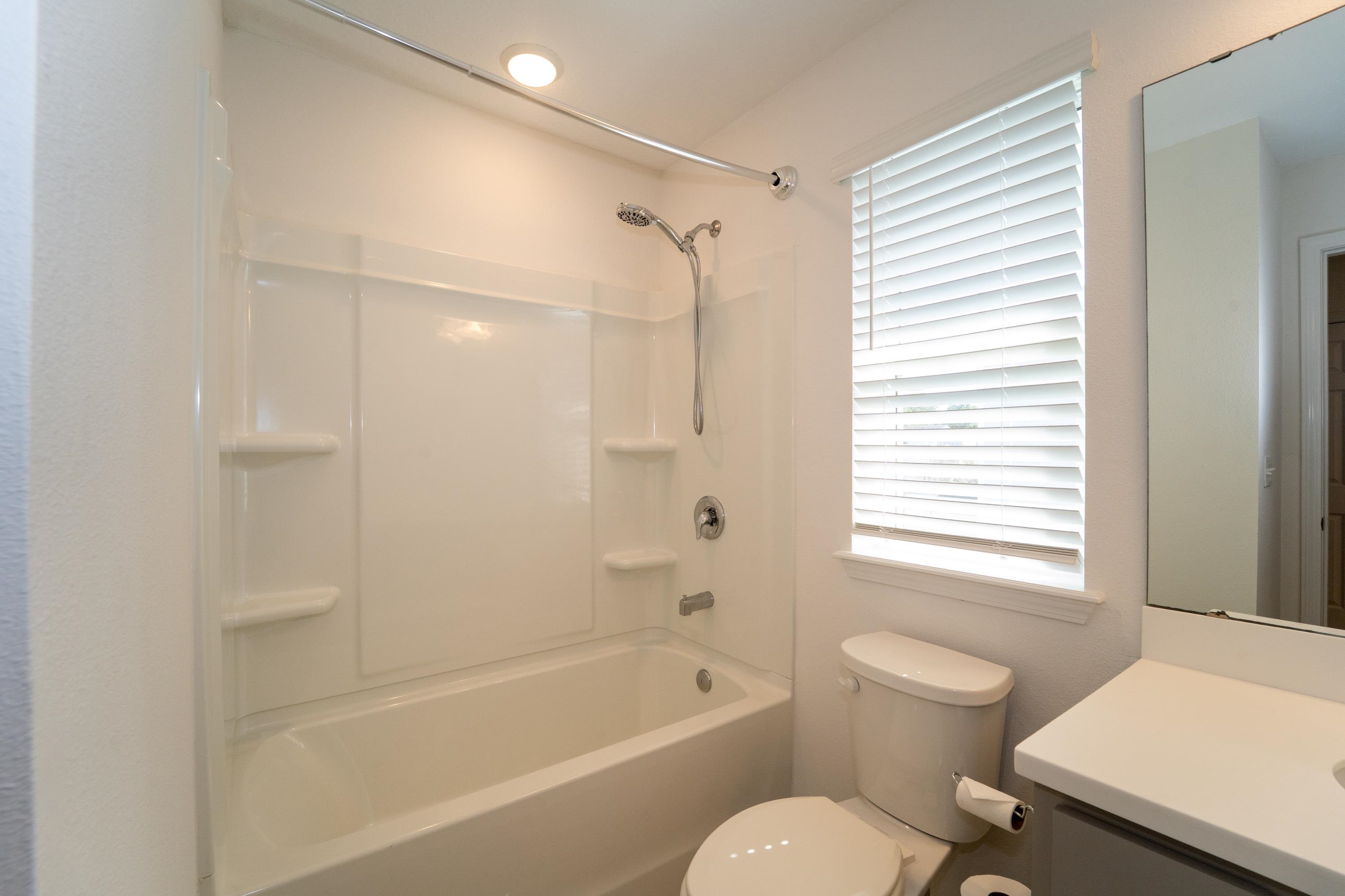 81 Ridge Lake Rd Street St. Augustine, FL 32086 - Photo 18 of 41 a bathroom with a bathtub shower sink vanity and toilet