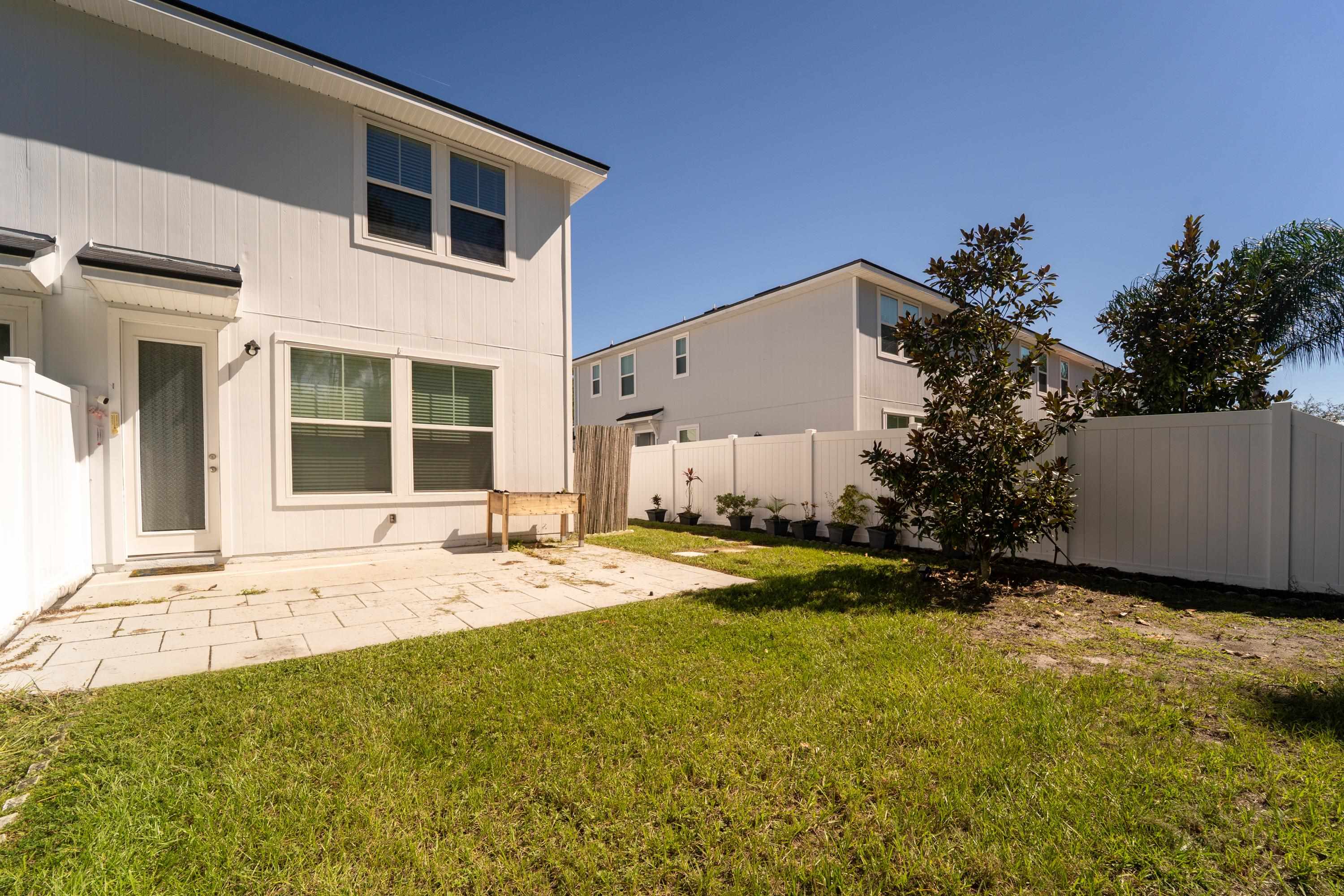 81 Ridge Lake Rd Street St. Augustine, FL 32086 - Photo 30 of 41 a view of a house with backyard and a garden