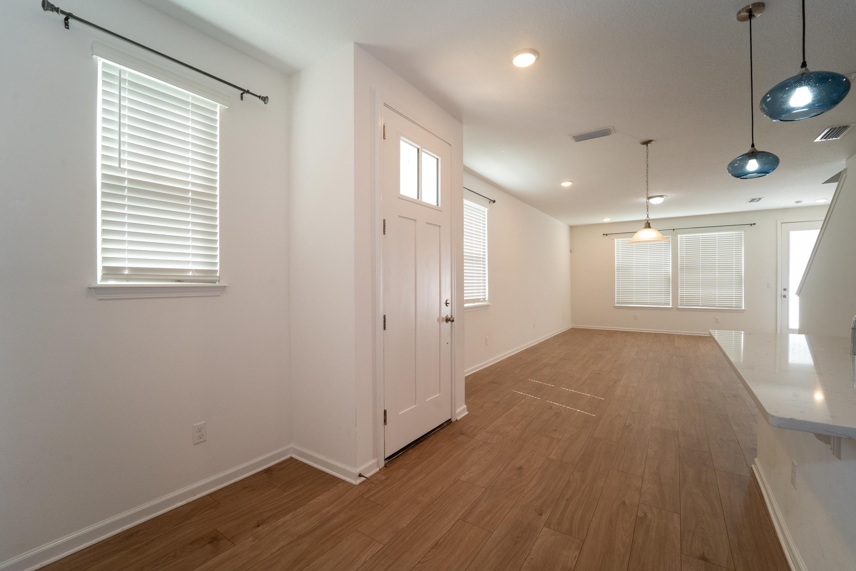 81 Ridge Lake Rd Street St. Augustine, FL 32086 - Photo 4 of 41 a view of an empty room with wooden floor and a window
