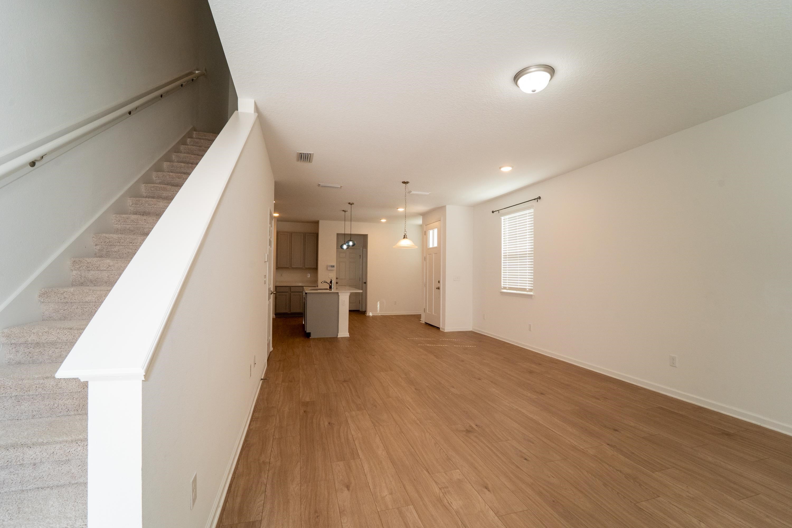 81 Ridge Lake Rd Street St. Augustine, FL 32086 - Photo 5 of 41 a view of a hallway with wooden floor and staircase