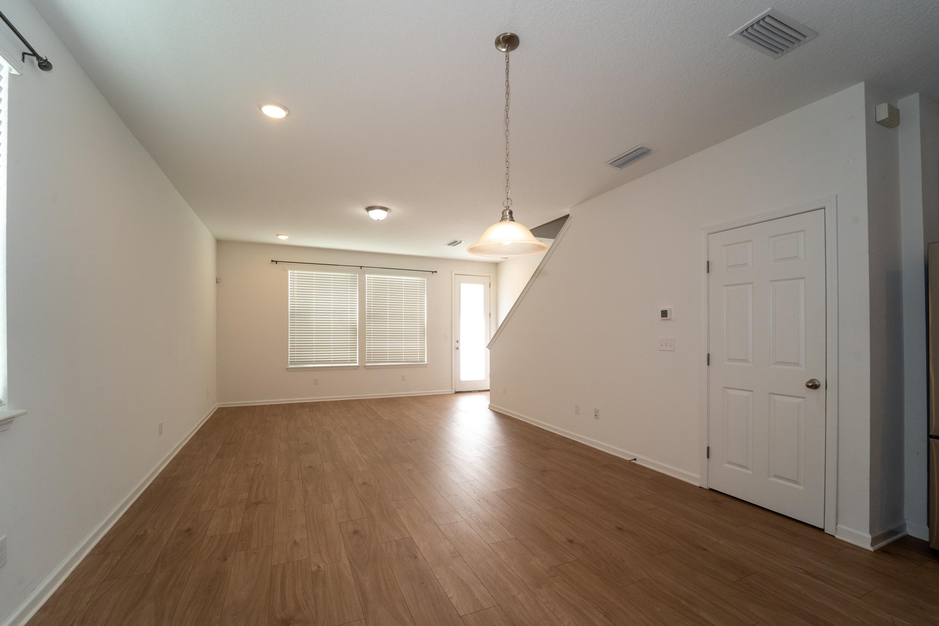 81 Ridge Lake Rd Street St. Augustine, FL 32086 - Photo 6 of 41 a view of an empty room with wooden floor and a window