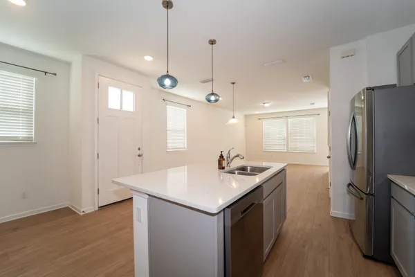 a kitchen with a sink refrigerator and window