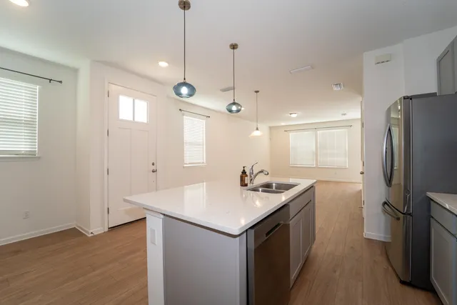 a kitchen with a sink refrigerator and window