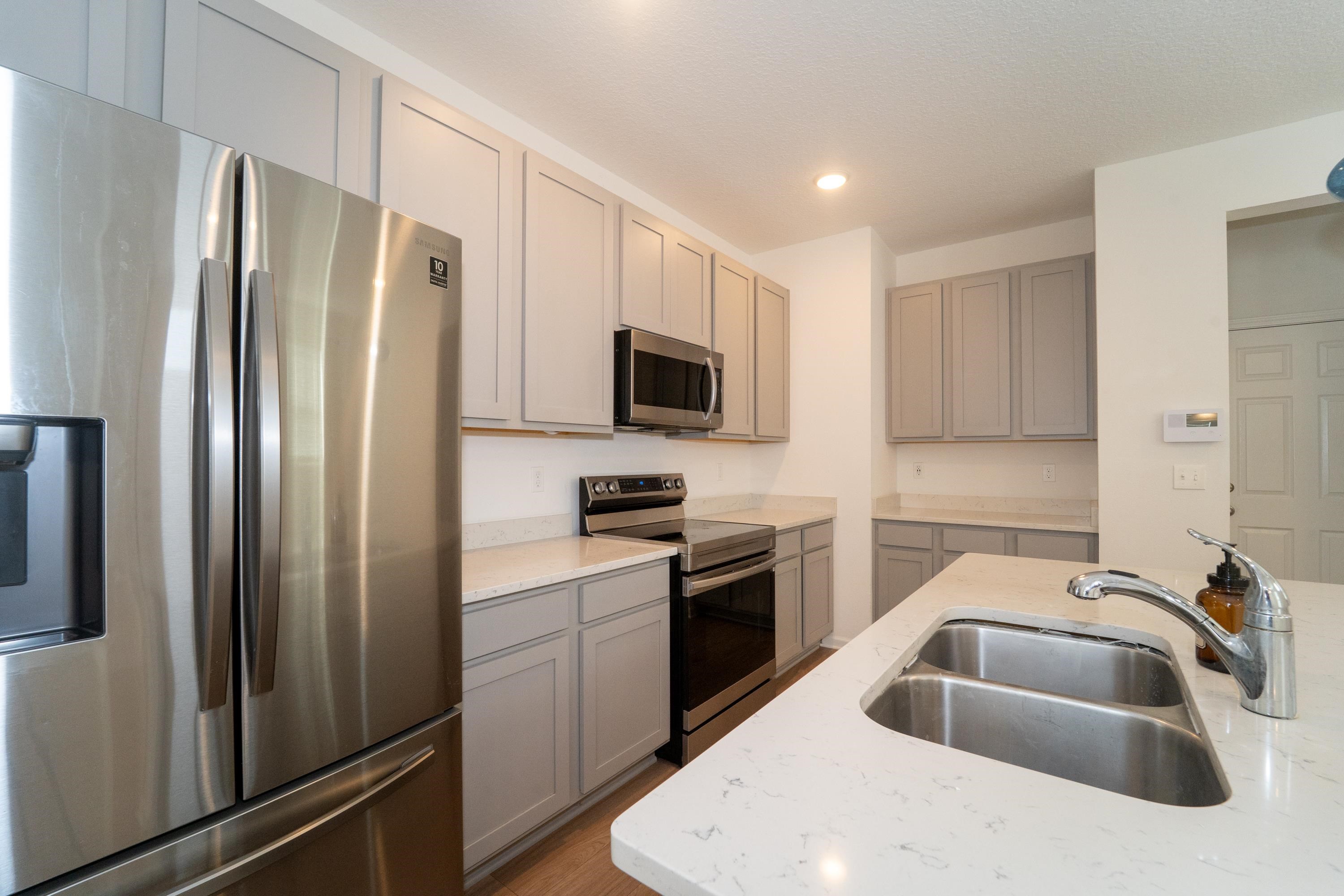 81 Ridge Lake Rd Street St. Augustine, FL 32086 - Photo 9 of 41 a kitchen with stainless steel appliances a refrigerator sink and microwave