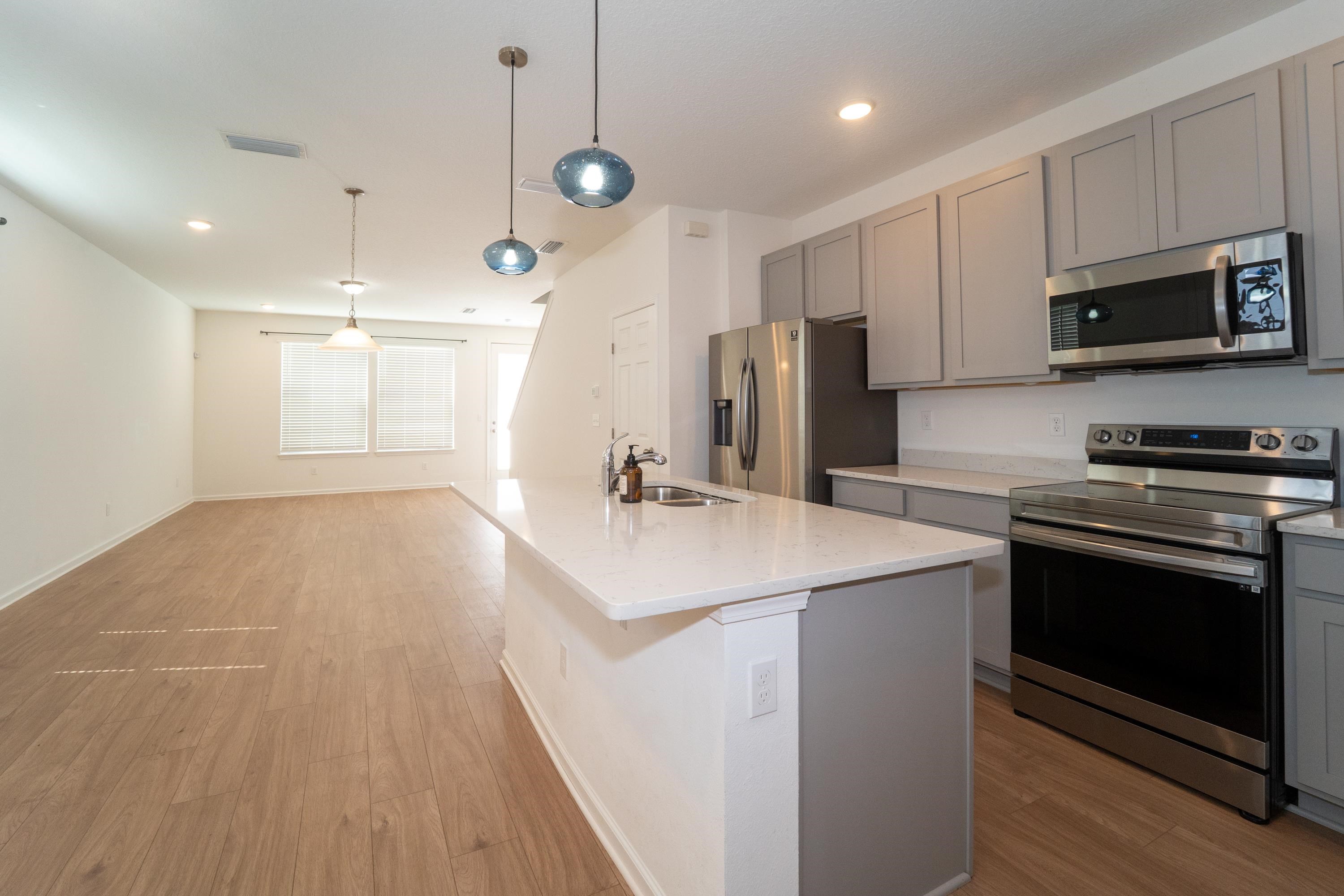 81 Ridge Lake Rd Street St. Augustine, FL 32086 - Photo 10 of 41 a kitchen with kitchen island a sink stainless steel appliances and cabinets