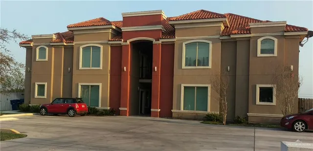a view of a brick building with many windows