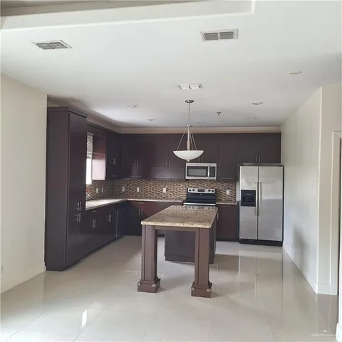 a kitchen with stainless steel appliances a sink and stove