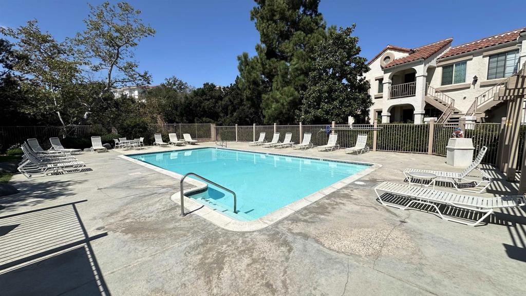 13062 Wimberly Square San Diego, CA 92128 - Photo 11 of 14 a view of a swimming pool with lounge chairs