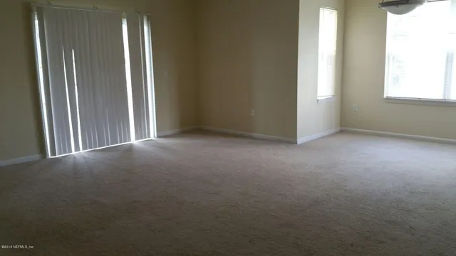 an empty room that has a window in it