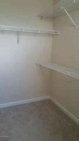 a view of an empty room with closet