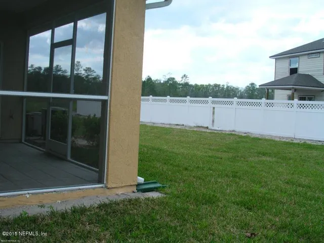 a view of a yard with potted plants