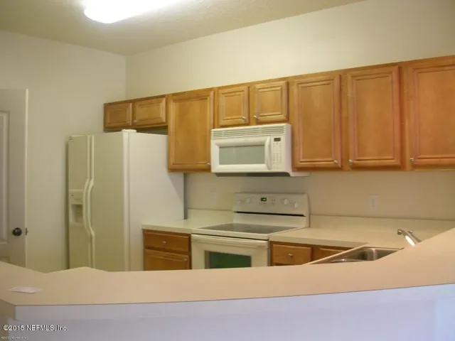 a kitchen with stainless steel appliances cabinets and a counter top space