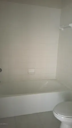 a bathroom with a bathtub and a toilet