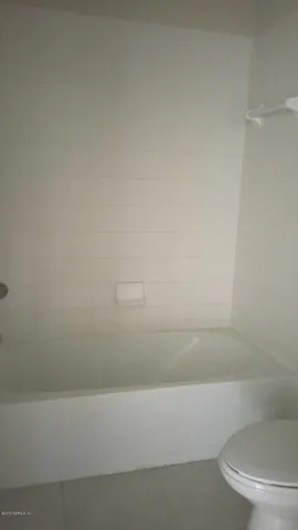 a bathroom with a bathtub and a toilet