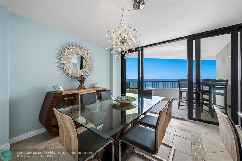600 Ocean Drive, Unit 8D Juno Beach, FL 33408 - Photo 7 of 37 a view of a dining room with furniture and chandelier