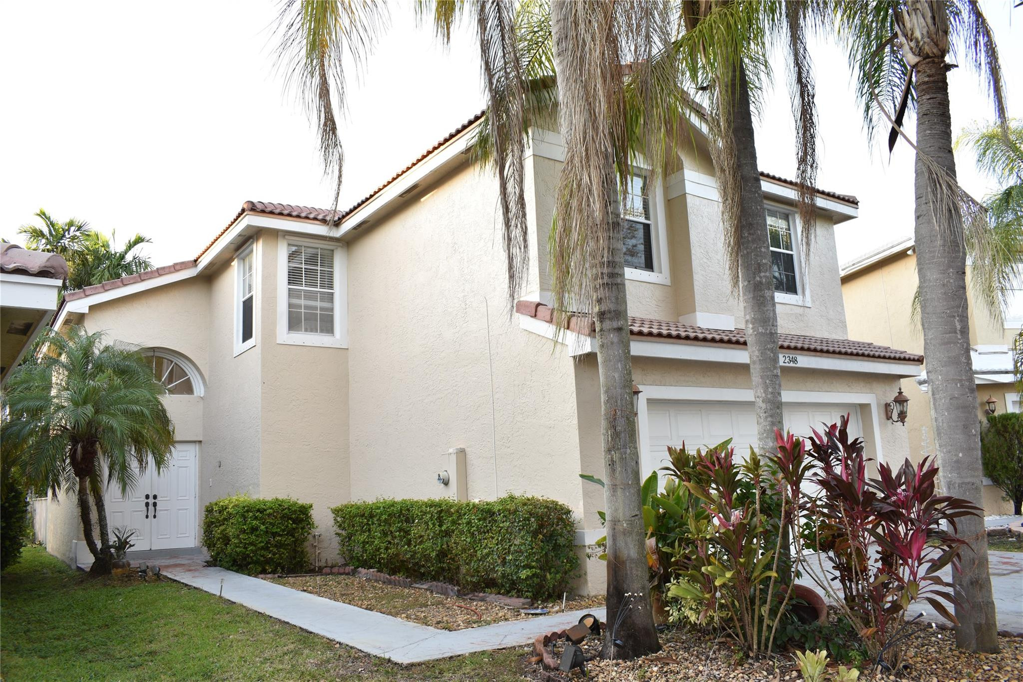 Undisclosed Address Miramar, FL 33029 - Photo 1 of 23 a front view of a house with a yard