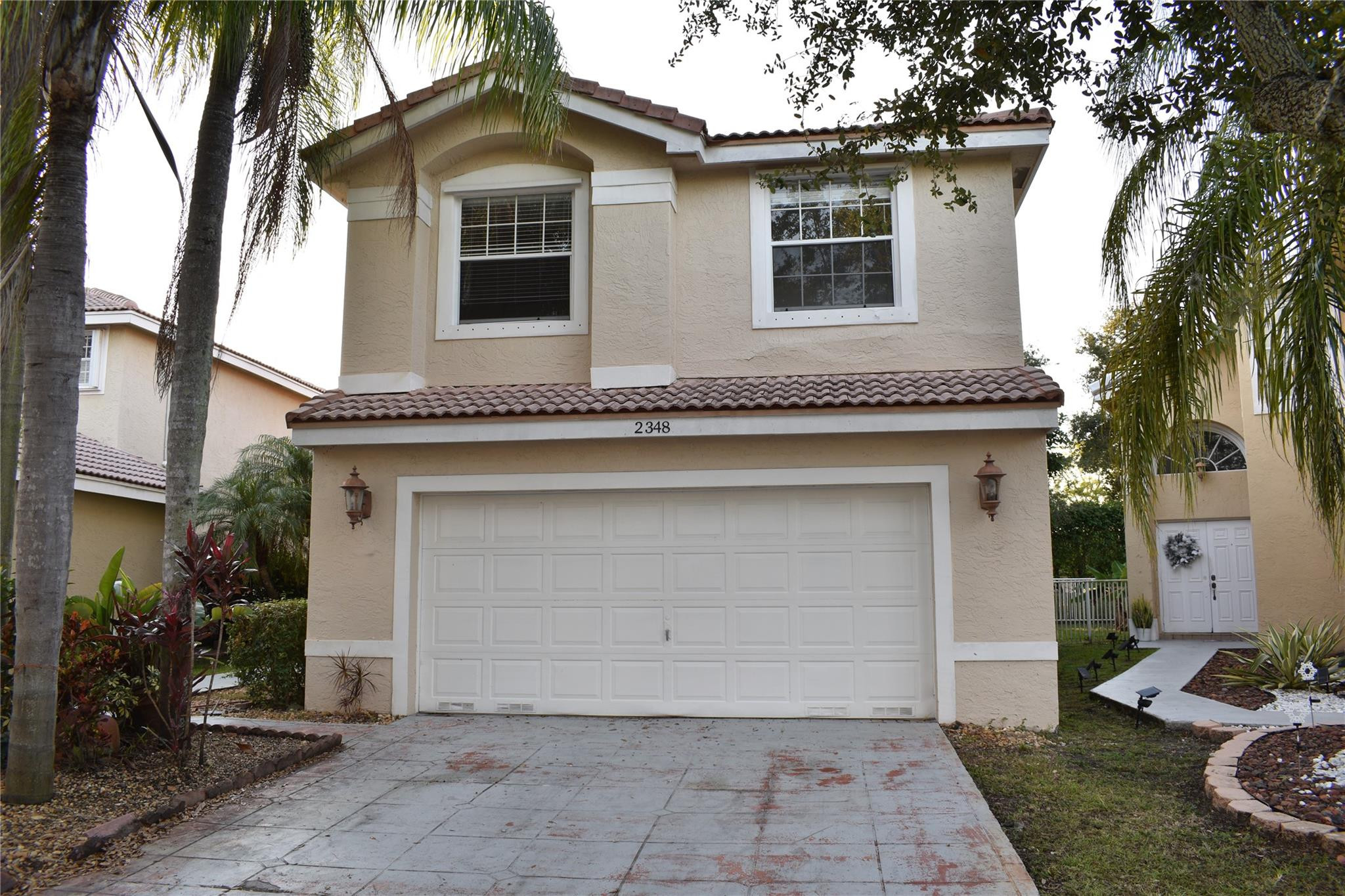 Undisclosed Address Miramar, FL 33029 - Photo 13 of 23 a front view of a house with garden