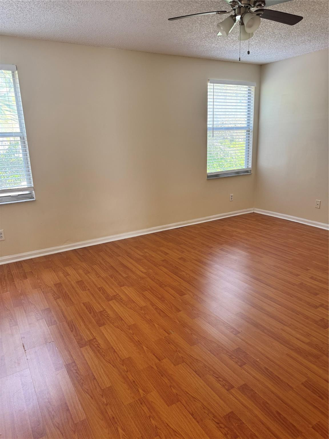 Undisclosed Address Miramar, FL 33029 - Photo 21 of 23 a view of an empty room with a window and wooden floor