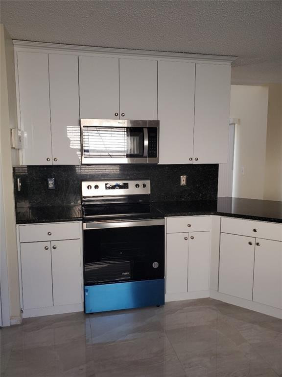 Undisclosed Address Miramar, FL 33029 - Photo 3 of 23 a kitchen with granite countertop white cabinets and black appliances