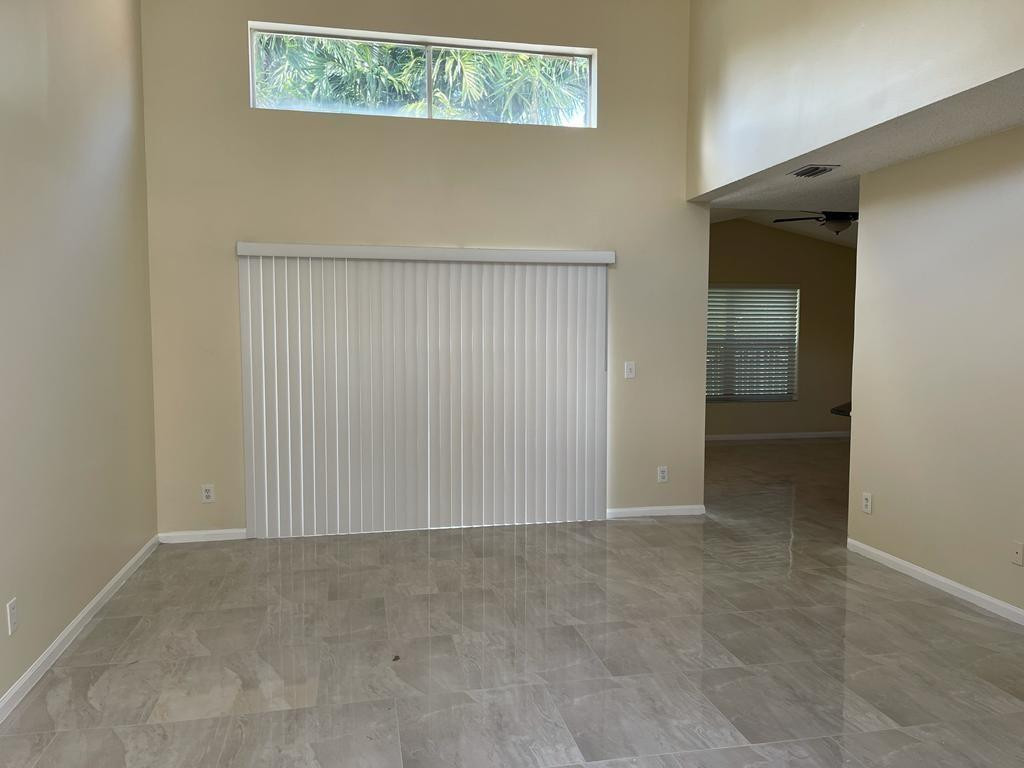 Undisclosed Address Miramar, FL 33029 - Photo 4 of 23 an empty room with a hallway