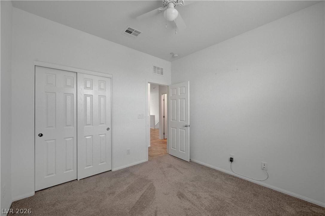 1287 Raritan Place Henderson, NV 89002 - Photo 18 of 21 A well-lit bedroom features ample closet space and a practical ceiling fan for comfortable living.