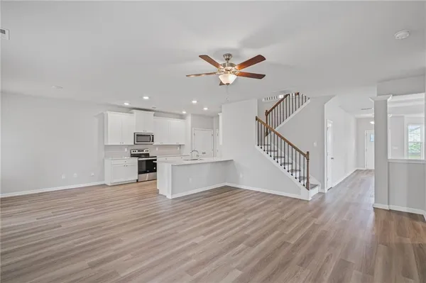 a view of kitchen with cabinets and wooden floor