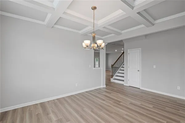 a view of a room with stairs and a chandelier fan