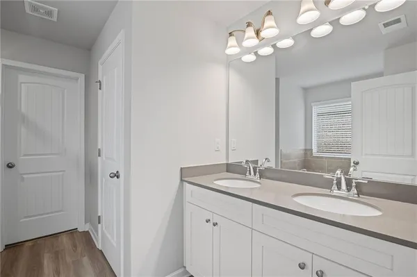 a bathroom with a sink vanity and a mirror