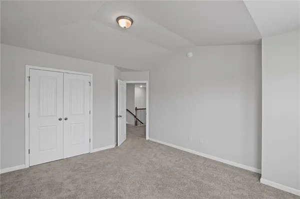an empty room with a window and a ceiling fan