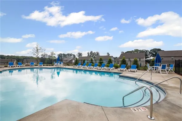 a view of a house with a big yard and a large tree