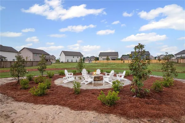 a view of a house with a yard and lake view