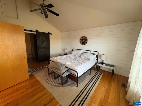 a view of a room with wooden floor and staircase