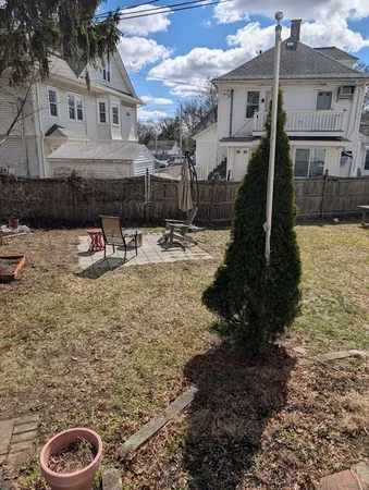a view of a house with a backyard