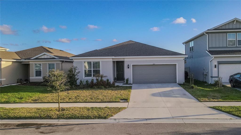 1821 Groveline Road St. Cloud, FL 34771 - Photo 1 of 36 a front view of a house with a garden