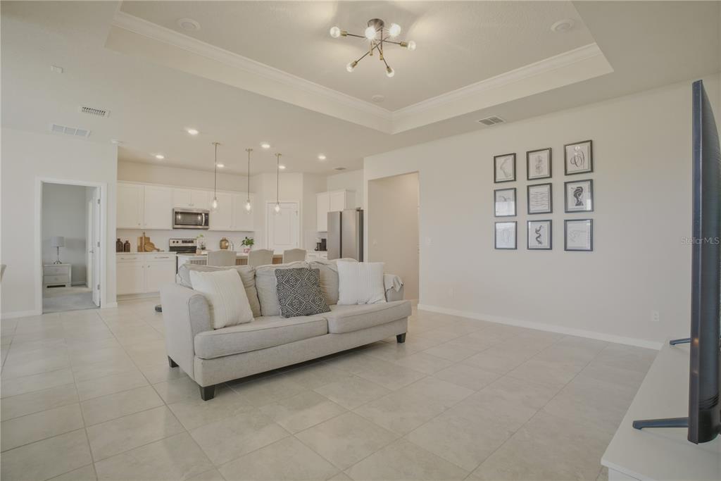 1821 Groveline Road St. Cloud, FL 34771 - Photo 13 of 36 a large white kitchen with kitchen island a sink stainless steel appliances and cabinets