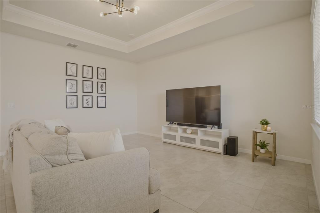 1821 Groveline Road St. Cloud, FL 34771 - Photo 14 of 36 a living room with furniture and a flat screen tv