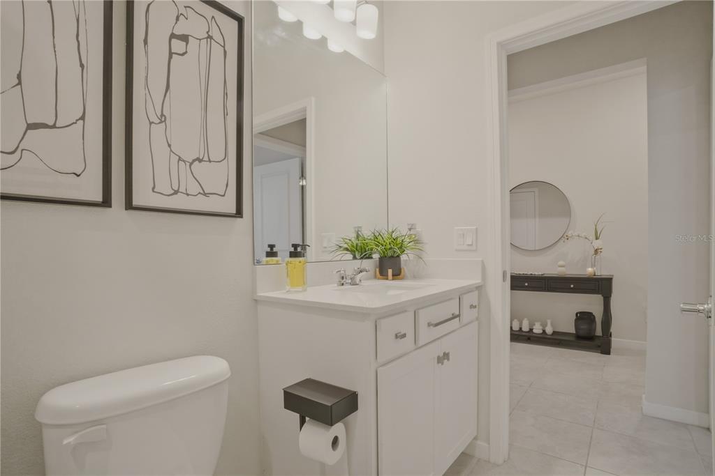 1821 Groveline Road St. Cloud, FL 34771 - Photo 22 of 36 a bathroom with a toilet a sink and a mirror