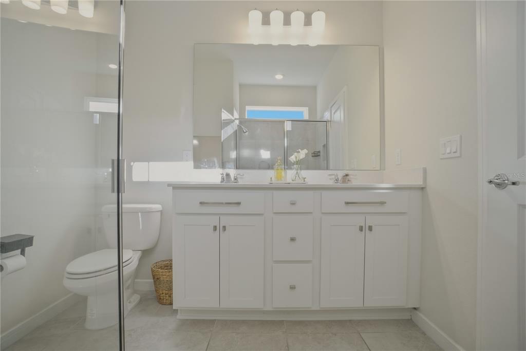 1821 Groveline Road St. Cloud, FL 34771 - Photo 28 of 36 a bathroom with a sink vanity and mirror