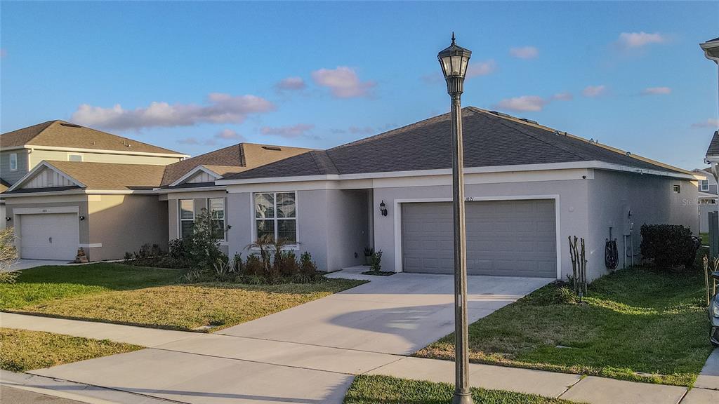 1821 Groveline Road St. Cloud, FL 34771 - Photo 3 of 36 a front view of a house with garden