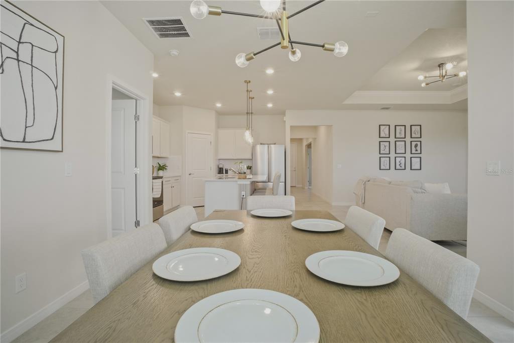 1821 Groveline Road St. Cloud, FL 34771 - Photo 8 of 36 a kitchen with stainless steel appliances wooden floor dining table and chairs