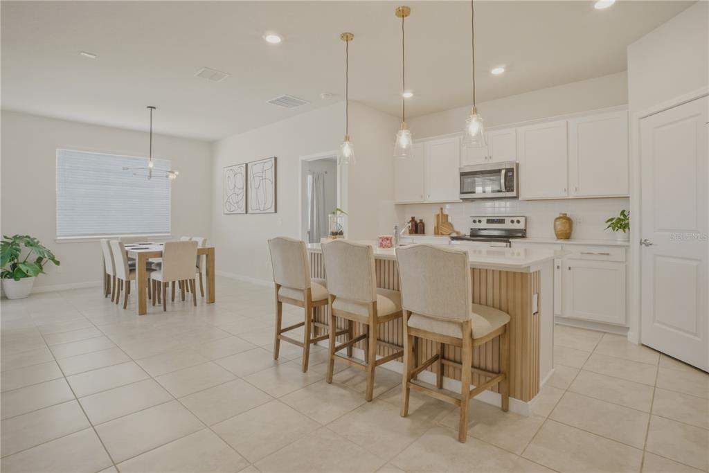 1821 Groveline Road St. Cloud, FL 34771 - Photo 10 of 36 a large kitchen with a table and chairs