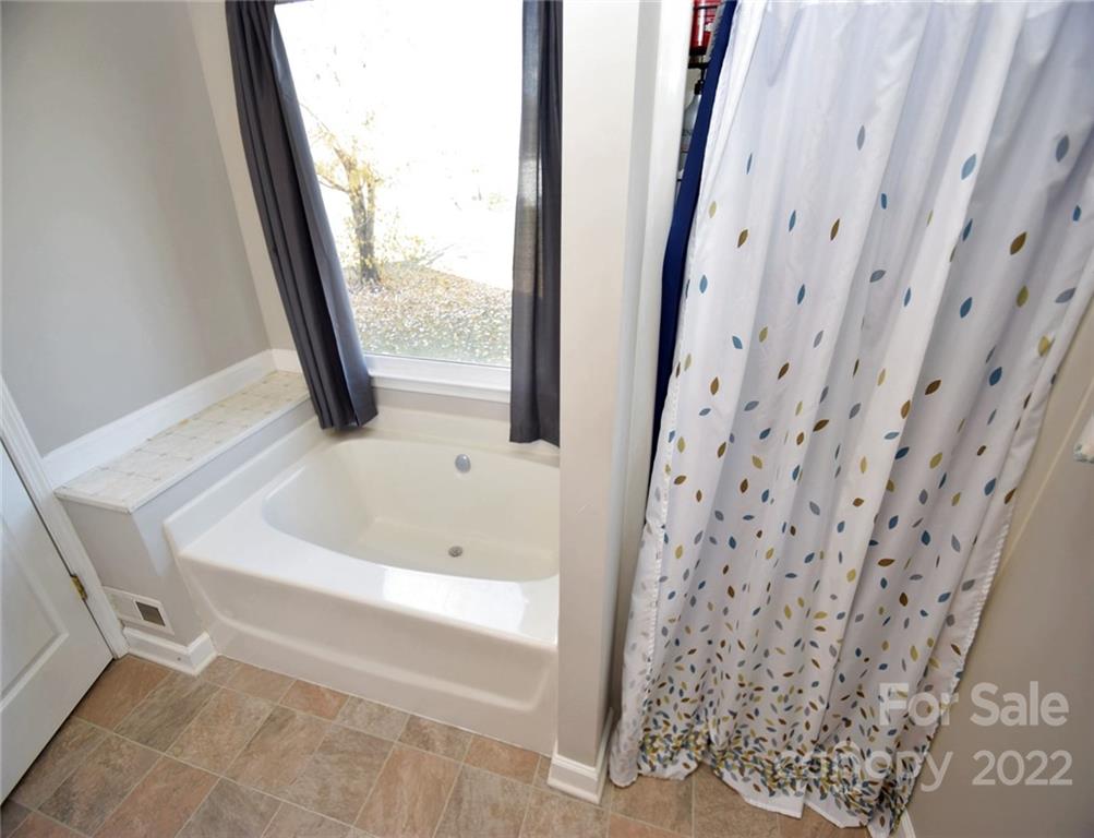 1909 Fletcher Broome Road, Unit 7 Monroe, NC 28112 - Photo 15 of 25 a bathroom with a bathtub and shower