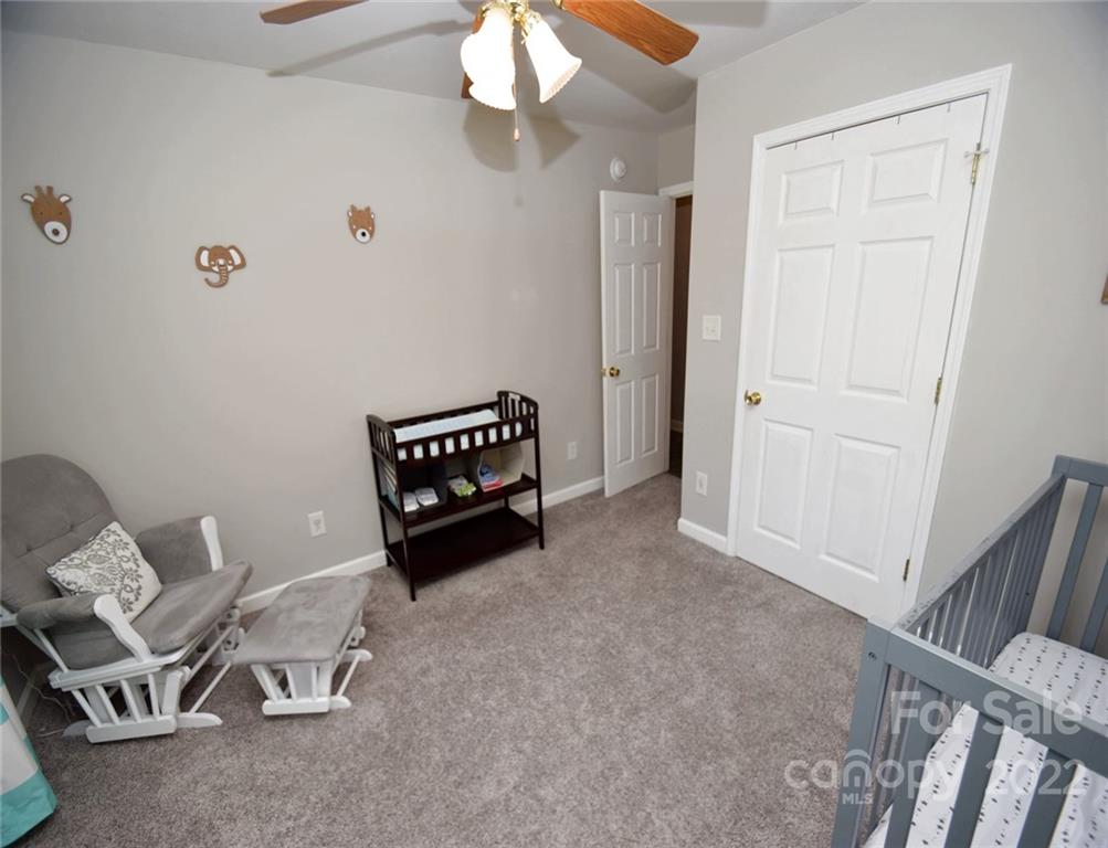 1909 Fletcher Broome Road, Unit 7 Monroe, NC 28112 - Photo 16 of 25 a living room with furniture and a chandelier